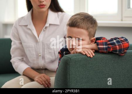Psychologist working with unhappy little boy in office. Mental health problems Stock Photo