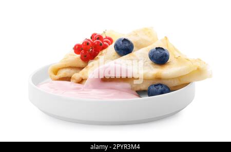 Delicious crepes with natural yogurt, blueberries and red currants on white background Stock Photo