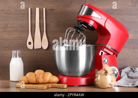 https://l450v.alamy.com/450v/2pyr4aw/modern-red-stand-mixer-croissant-and-cookies-on-wooden-table-2pyr4aw.jpg