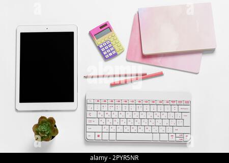 Composition with tablet computer, keyboard, pens and notebooks on white background Stock Photo