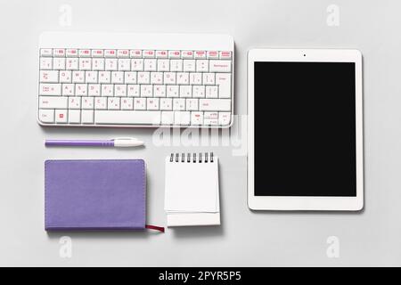 Composition with tablet computer, keyboard, pen and notebooks on white background Stock Photo