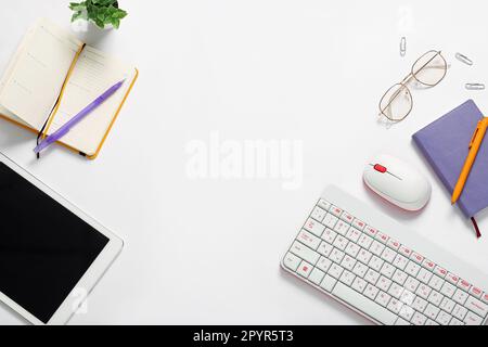 Composition with tablet computer, keyboard, notebook and glasses on white background Stock Photo