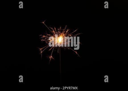 One burning sparkler stick on black background Stock Photo