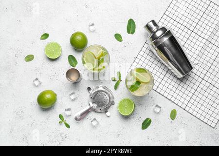 Glasses of tasty mojito and ingredients on light background Stock Photo