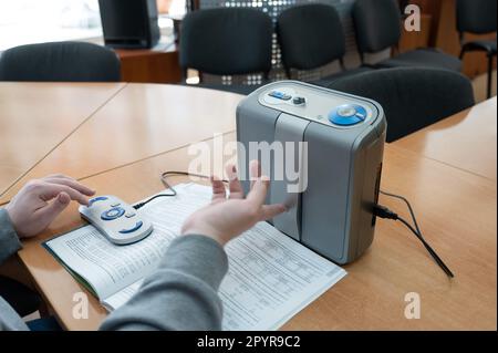 A visually impaired man uses a scanning and reading machine. Stock Photo