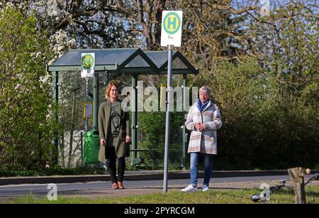 Millienhagen, Germany. 03rd May, 2023. Maria S. Kasten (l-r) and Diana Nurkewitz stand at the bus stop in the village where the children get on every morning at 6:12 a.m. and get off at 4:40 p.m. who have to go to the high school in Grimmen. The children spend three hours on buses every day. The mothers are fighting in a parents' initiative for shorter commute times. Credit: Bernd Wüstneck/dpa/Alamy Live News Stock Photo