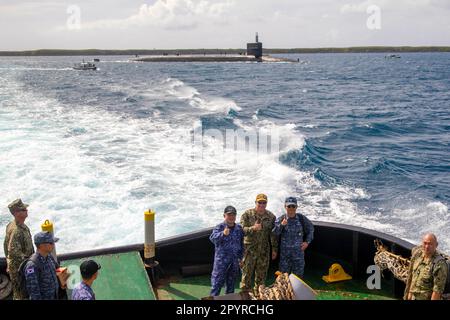 230418-N-YU102-1286 APRA HARBOR, Guam (April 18, 2023) From left, Japan Maritime Self-Defense Force (JMSDF) Vice Adm. Tateki Tawara, commander, Fleet Submarine Force; U.S. Navy Rear Adm. Rick Seif, commander, Submarine Group 7; and Republic of Korea (ROK) Navy Rear Adm. Su Youl Lee, commander, ROK Navy Submarine Force; pose for a photo aboard a tug boat as they approach the Ohio-class ballistic missile submarine USS Maine (SSBN 741), April 18. During their time at sea aboard the submarine, the senior leaders were provided tours and demonstrations of the unit’s capabilities, which operates glob Stock Photo