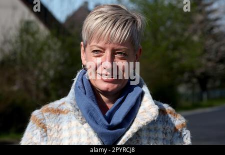 Millienhagen, Germany. 03rd May, 2023. Diana Nurkewitz stands at the bus stop in the village where the children get on every morning at 6:12 a.m. and get off at 4:40 p.m. who have to go to the high school in Grimmen. The children spend three hours on buses every day. The mothers are fighting in a parents' initiative for shorter commute times. Credit: Bernd Wüstneck/dpa/Alamy Live News Stock Photo
