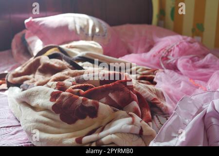 Bed with messy pick color Blankets, Stock Photo