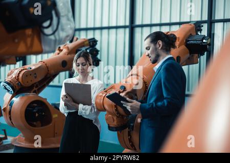 Robotic factory owner explain, discuss functionality and performance of robot systems with client. Answering questions about after-sales service. Pric Stock Photo