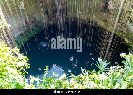 People swimming in limestone sinkhole pool, Cenote Ik kil, Pisté, Yucatan, Mexico Stock Photo