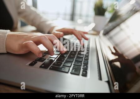 man hand printing jobs using a laptop keyboard at the office. Stock Photo