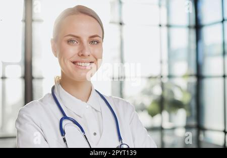 Confident female doctor posing in her office Stock Photo