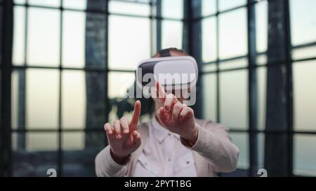 Office employee having fun at work, watching 3D video in virtual reality glasses Stock Photo