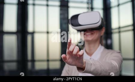 Office employee having fun at work, watching 3D video in virtual reality glasses Stock Photo