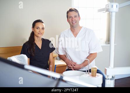 Youre in very capable hands. Cropped portrait of a dentist standing with his assistant. Stock Photo