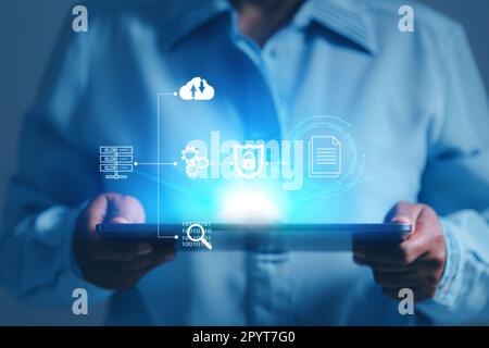 Online documentation database and process automation to efficiently manage files, IT staff working with Document Management System (DMS), Corporate bu Stock Photo