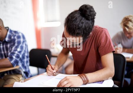 Working hard for good grades. young university students during class. Stock Photo