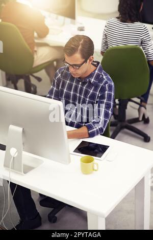 Designer at work. a colleagues at work on computers in an office. Stock Photo