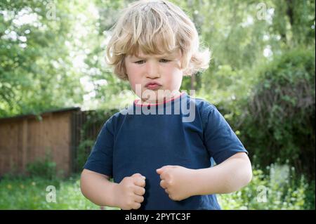 child pretending to be strong man Stock Photo - Alamy