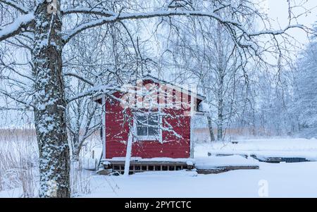 Red house in the snow in Finland Stock Photo