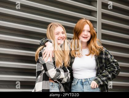 Two happy teen girls hugging and hanging out. Stock Photo