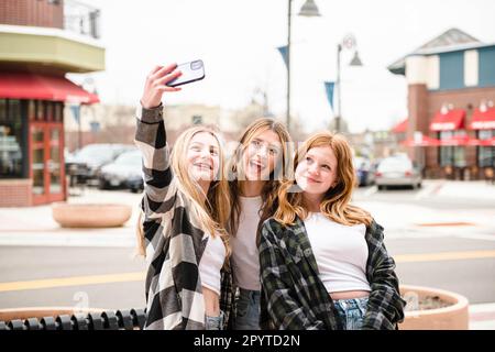 Three happy teen girls taking a selfie. Stock Photo