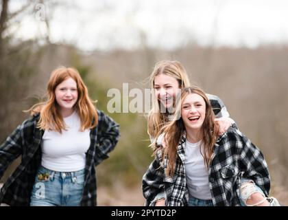 Three beautiful teen girls having fun together outdoors. Stock Photo