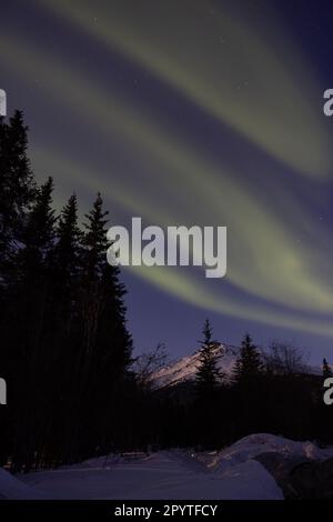Northen Lights over a mountain in Wiseman, Alaska Stock Photo