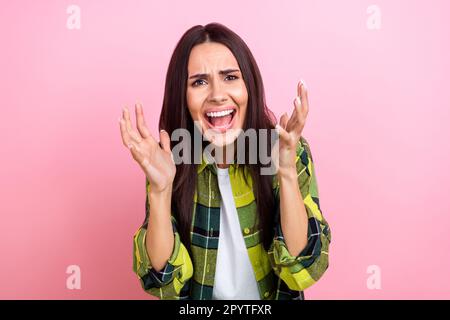 Photo of shocked irritated lady wear checkered jacket screaming rising hands arms isolated pink color background Stock Photo