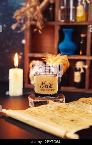 Antique inkwell with quill and parchment. In the background is a wooden rack with bottles and potions. Stock Photo