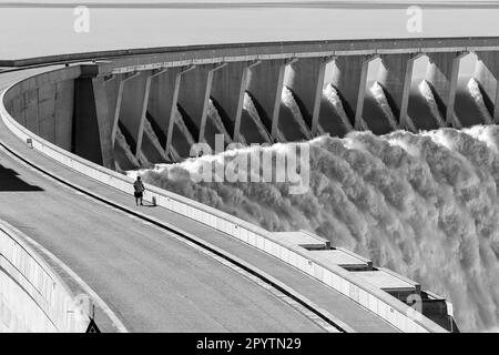 Gariepdam, South Africa - Feb 21, 2022: The largest dam in South Africa, the Gariep Dam, overflowing. It is in the Orange River. People are visible fo Stock Photo