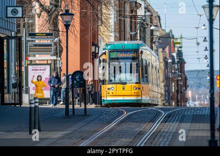 Tram on main street Drottningatan in the city center of Norrköping, Sweden. The yellow trams are iconic for Norrköping. Stock Photo