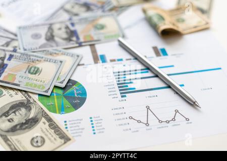 business graph chart paper pen calculator us dollar on office desk. Checking financial reports. Stock Photo