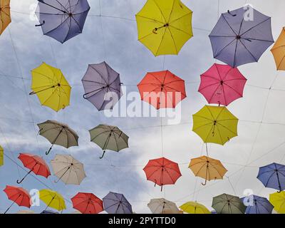 Colorful umbrellas against the blue sky at I Love Agra Selfie Point in Agra, Uttar Pradesh, India Stock Photo