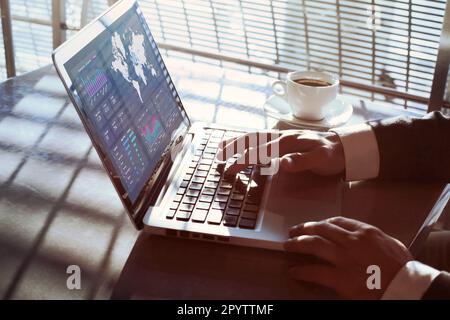 financial dashboard on computer screen, data analytics, close up of hands of businessman Stock Photo