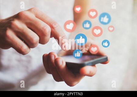social media concept, likes on social network coming from smartphone screen Stock Photo