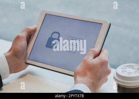 user typing login and password on digital tablet computer, data protection and internet security concept Stock Photo