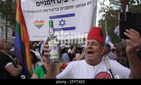 A right wing protestor holds a bottle of Arak a traditional