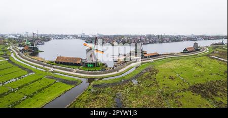drone panorama of authentic Zaandam mills on the water channel in Zaanstad village. Zaanse Schans Windmills and famous Netherlands canals. High quality photo Stock Photo