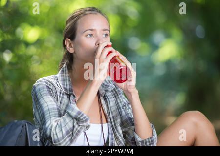 young asian woman drinking water in the forest Stock Photo