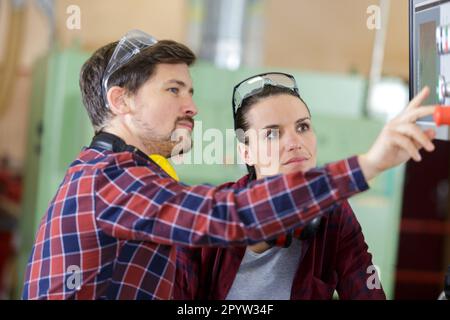 man and woman with machine cnc Stock Photo