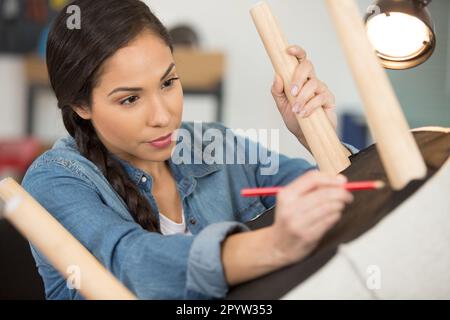 womanan working in upholstery workshop Stock Photo