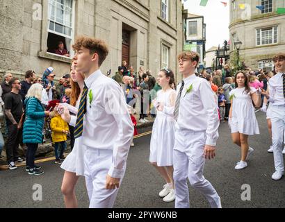 Helston,Cornwall,5th May 2023,Flora Day which is an ancient spring festival took place today in Helston, Cornwall. It celebrates the end of winter and marks the arrival of spring. Thousands of people attend to line the streets and watch the amazing dances which started at 7am. In that first dance couples dance through the streets entering selected houses. Hal an Tow afterwards tells the history of Helston. Mid Morning there is a Children’s dance with over a thousand children dancing from local schools all dancing in White.Credit:Keith Larby/Alamy Live News Stock Photo