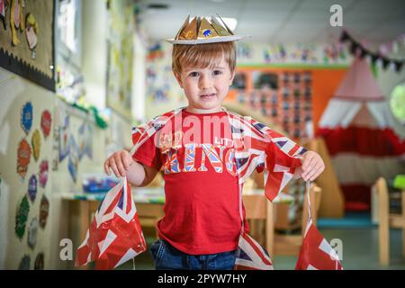 Pictured is a pupil from Waunarlwydd Primary School in Swansea, dressed-up to celebrate the Coronation of His Majesty The King on Saturday as members of the public across the UK get ready for the historical event which will see the crowning of King Charles. Pupils at the school were given the chance to wear red, white and blue for their school uniform and took part in coronation events through-out the day. Stock Photo