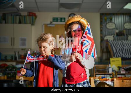 Pictured are pupils from Waunarlwydd Primary School in Swansea, dressed-up to celebrate the Coronation of His Majesty The King on Saturday as members of the public across the UK get ready for the historical event which will see the crowning of King Charles. Pupils at the school were given the chance to wear red, white and blue for their school uniform and took part in coronation events through-out the day. Stock Photo