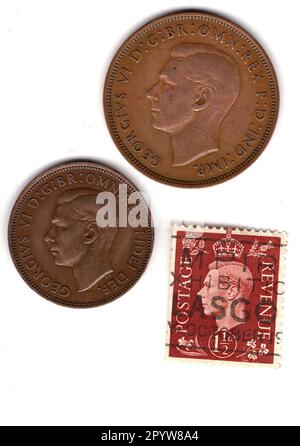 One and a half pence coins and stamp from the reign of King George VI isolated on a white background. Stock Photo