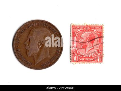 One penny coin and stamp from the reign of King George V isolated on a white background. Stock Photo