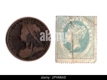 One penny coin and stamp from the reign of Queen Victoria isolated on a white background. Stock Photo