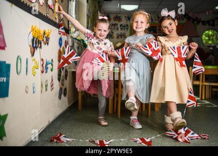 Pictured are pupils from Waunarlwydd Primary School in Swansea, dressed-up to celebrate the Coronation of His Majesty The King on Saturday as members of the public across the UK get ready for the historical event which will see the crowning of King Charles. Pupils at the school were given the chance to wear red, white and blue for their school uniform and took part in coronation events through-out the day. Stock Photo